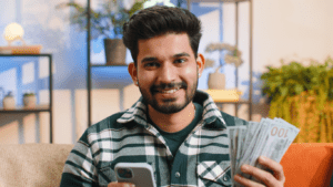a person holding a money and a phone